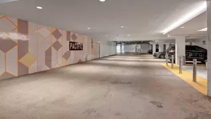 "The Pacific Luxury Apartments' secure parking garage with modern design elements, bright lighting, and convenient access to resident vehicles."