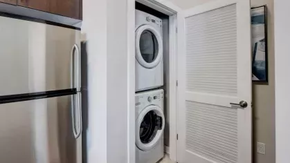 A laundry area with stacked washer and dryer units conveniently tucked into a closet.
