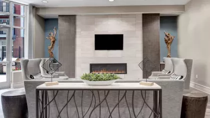 Contemporary lounge area with a sleek electric fireplace and cozy seating.