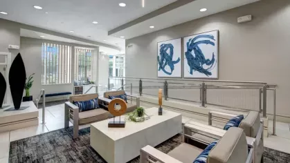 Inviting lobby seating area with artistic decor and large windows.