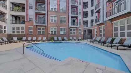 Another perspective of the pool courtyard, showing its symmetrical design and surrounding lounge seating.