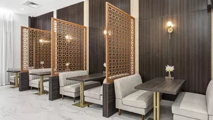 Stylish booth seating in a communal lounge area at Pine Ridge Luxury Apartments, with elegant geometric dividers for added privacy.