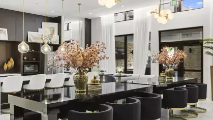 Luxurious meeting and lounge area with dark wood furnishings, polished surfaces, and modern lighting.