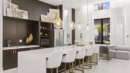 Luxurious meeting and lounge area with dark wood furnishings, polished surfaces, and modern lighting.