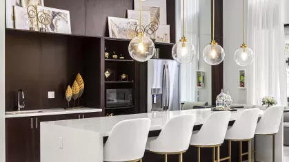 Luxurious meeting and lounge area with dark wood furnishings, polished surfaces, and modern lighting.