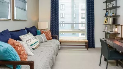 Functional and beautifully designed home office space with ample natural light and modern furnishings at Riverworks Luxury Apartments.