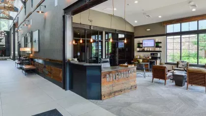 Stylish front desk at Riverworks Luxury Apartments with industrial design elements and welcoming ambiance.
