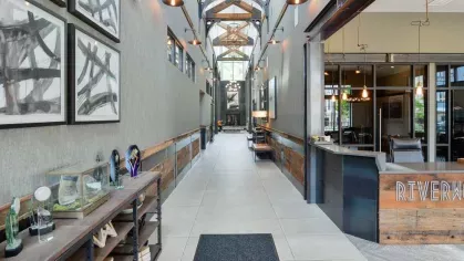 Spacious hallway at Riverworks Luxury Apartments showcasing contemporary art and unique architectural design.