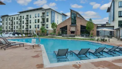 Expansive pool area with ample seating and beautifully maintained surroundings at Riverworks.