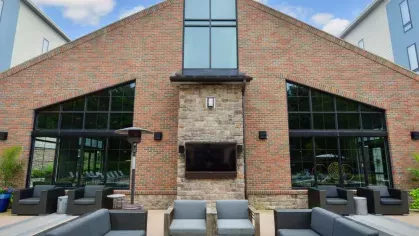 Contemporary outdoor fireplace and lounge space at Riverworks Luxury Apartments, perfect for socializing and relaxation.