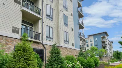 Beautifully landscaped garden area at Riverworks Luxury Apartments, featuring vibrant greenery, well-maintained flower beds, and the contemporary design of the apartment buildings.
