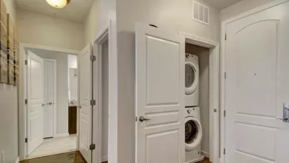 A utility space with a stacked washer and dryer conveniently located near the entryway of the apartment.