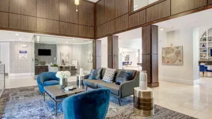 The leasing office lounge with plush seating, modern decor, and ample lighting, offering a welcoming environment for residents and guests.