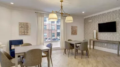 A cozy study or meeting space with individual tables, warm lighting, and soft seating, designed for focused activities.