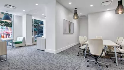 Collaborative workspace featuring cozy seating areas, natural lighting, and contemporary furniture.