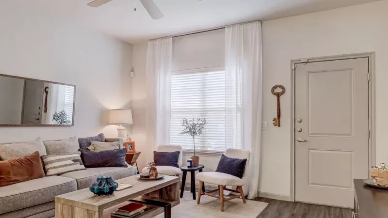 Stylish living room at The Emerson at Forney with modern furniture, natural light, and cozy decor for a welcoming atmosphere.
