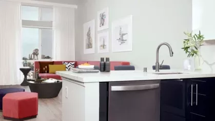 Open-concept living space at The Linden featuring a bright living area with modern furnishings and direct access to the kitchen.