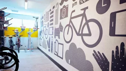 Secure bike storage at The Linden Luxury Apartments with wall-mounted racks and vibrant, artistic wall graphics.
