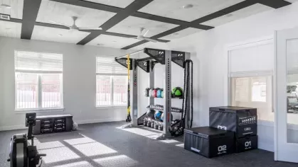 Bright and open exercise space with functional training equipment, medicine balls, and plyometric boxes, ideal for versatile workouts.