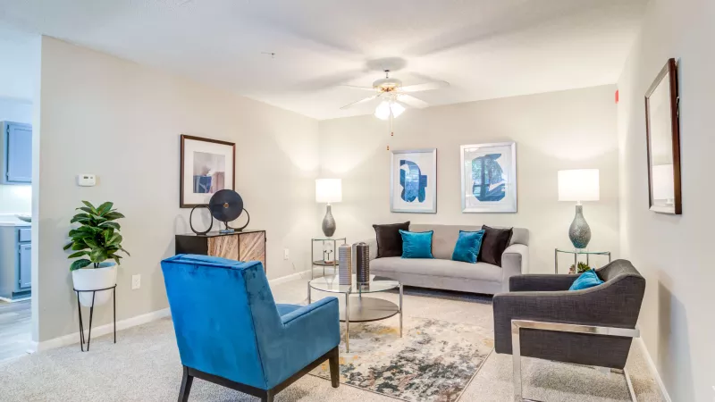 Stylish living room with modern furniture, neutral tones, and accent lighting.
