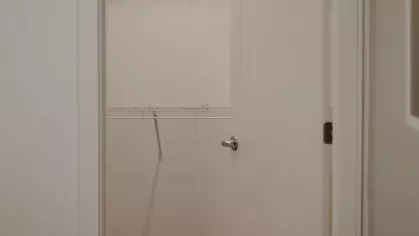 A walk-in closet with ample shelving and hanging space, providing generous storage in a thoughtfully designed apartment.