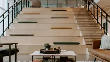 A cozy communal area with tiered seating, built-in cushions, and a stylish coffee table, creating the perfect environment for socializing or relaxing.