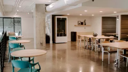 A spacious communal area with a modern staircase featuring built-in seating, providing a unique and functional gathering space at Industry Columbus Apartments.