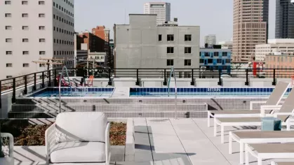 A decorative "Industry Works" wall feature with wooden lettering and modern greenery, creating a welcoming atmosphere at Industry Columbus Apartments.