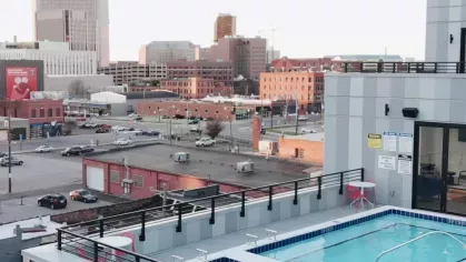 A stunning rooftop pool with panoramic views of downtown Columbus, offering a vibrant urban living experience at Industry Columbus Apartments.