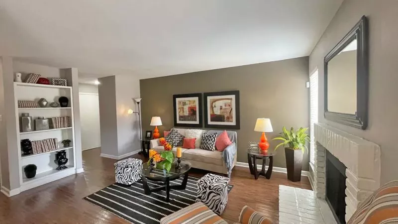 A cozy living room with a fireplace, modern furniture, and stylish decor, offering a warm and inviting space.