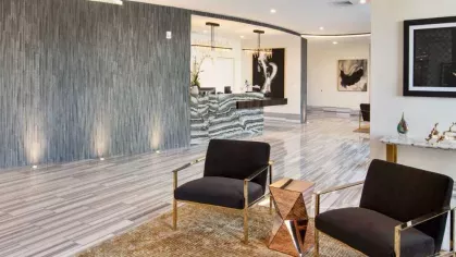 A luxurious lounge area with contemporary seating, warm lighting, and a sophisticated design.