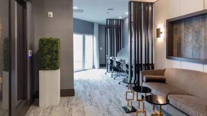 A chic coworking space with comfortable seating, modern decor, and private workstations.