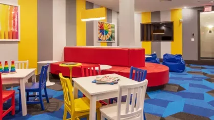 A colorful children's playroom with interactive seating, bright decor, and an engaging atmosphere.
