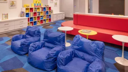 A playful lounge space with vibrant seating, a modern design, and fun entertainment options.