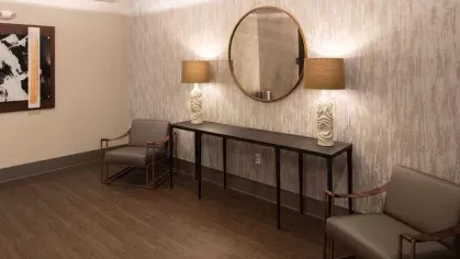  A sophisticated hallway with elegant decor, ambient lighting, and contemporary furnishings.