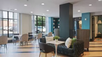 A sleek and modern conference room with glass-paneled doors, black leather chairs, and a sophisticated ambiance.