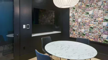 A chic bar area with elegant pendant lighting, a marble countertop, and comfortable seating for social gatherings.