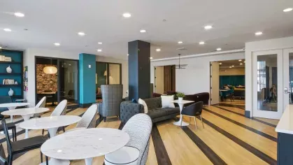 A private study nook with a modern round table, textured walls, and ambient lighting for a focused environment.