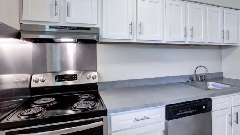 Modern kitchen with white cabinets, sleek countertops, and stainless steel appliances at Silver Lake Manor Apartments.