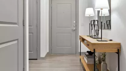 A welcoming entryway with a minimalist console table, decorative accents, and soft lighting.
