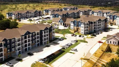 Wide aerial shot of a luxury apartment complex surrounded by rolling hills, with well-planned roads, lush greenery, and community amenities.