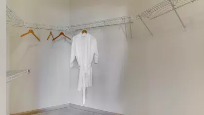 A large walk-in closet with built-in shelving and hanging space, providing ample storage for a well-organized lifestyle.