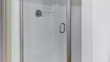 A bright and well-equipped fitness center featuring treadmills, elliptical machines, and large windows for natural light.