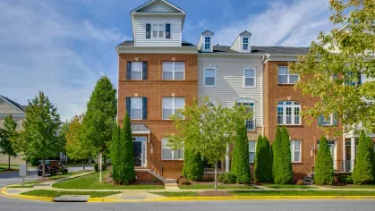 A stately brick and siding apartment building with well-manicured landscaping, exuding timeless charm and modern appeal.