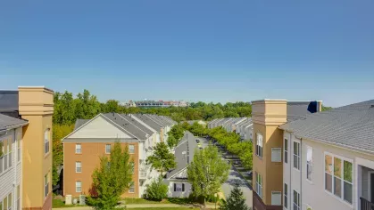 A breathtaking aerial perspective showcasing rows of well-designed apartment buildings nestled among tree-lined streets.