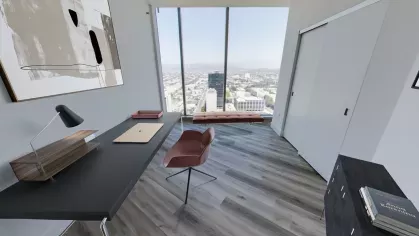 Penthouse home office at Nari Koreatown with a sleek desk, abstract art, and a floor-to-ceiling window framing the skyline