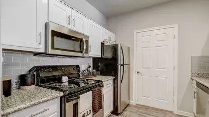Stylish kitchen with granite countertops, subway tile backsplash, and stainless steel appliances at Gates at Citiplace in Baton Rouge