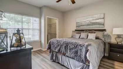 Spacious bedroom with updated lighting and neutral tones at Gates at Citiplace apartment homes in Baton Rouge.