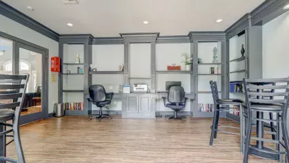 Full view of Gates at Citiplace's bright and inviting business center with multiple workspaces and seating options