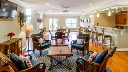 Resident clubhouse with bar seating, social lounge chairs, and dining tables